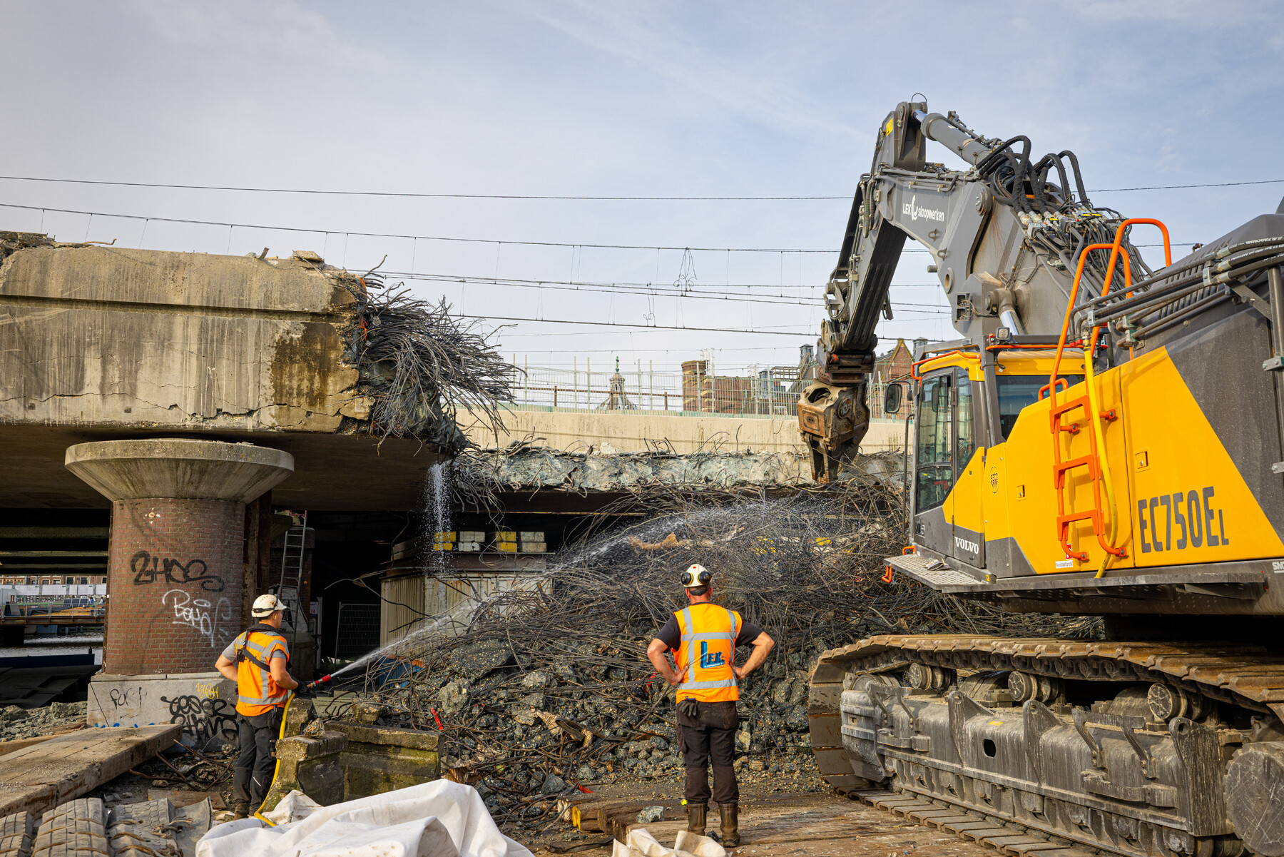 Het puin wordt natgespoten om stofvorming te voorkomen