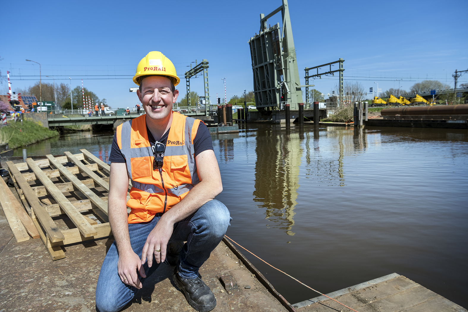Bastiaan Logtmeijer, bouwmanager, met op de achtergrond de geopende spoorbrug