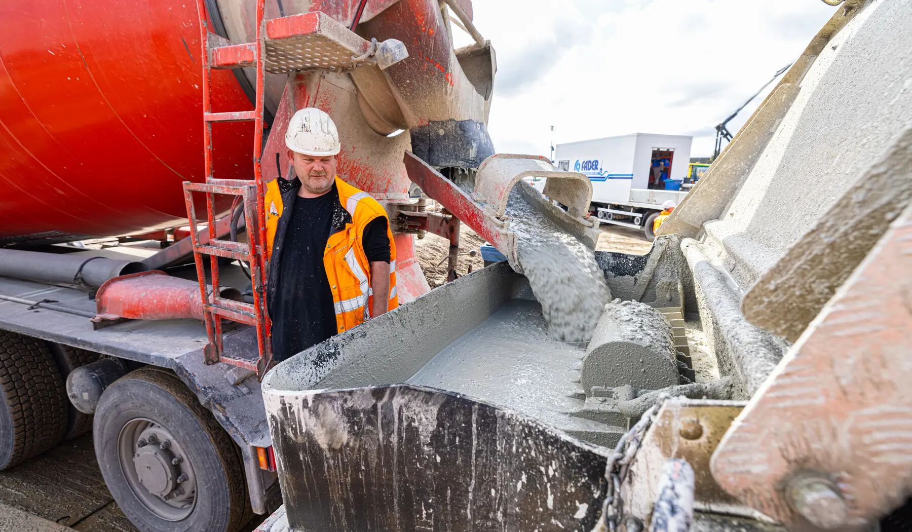 Het overstorten van beton van vrachtwagen naar machine