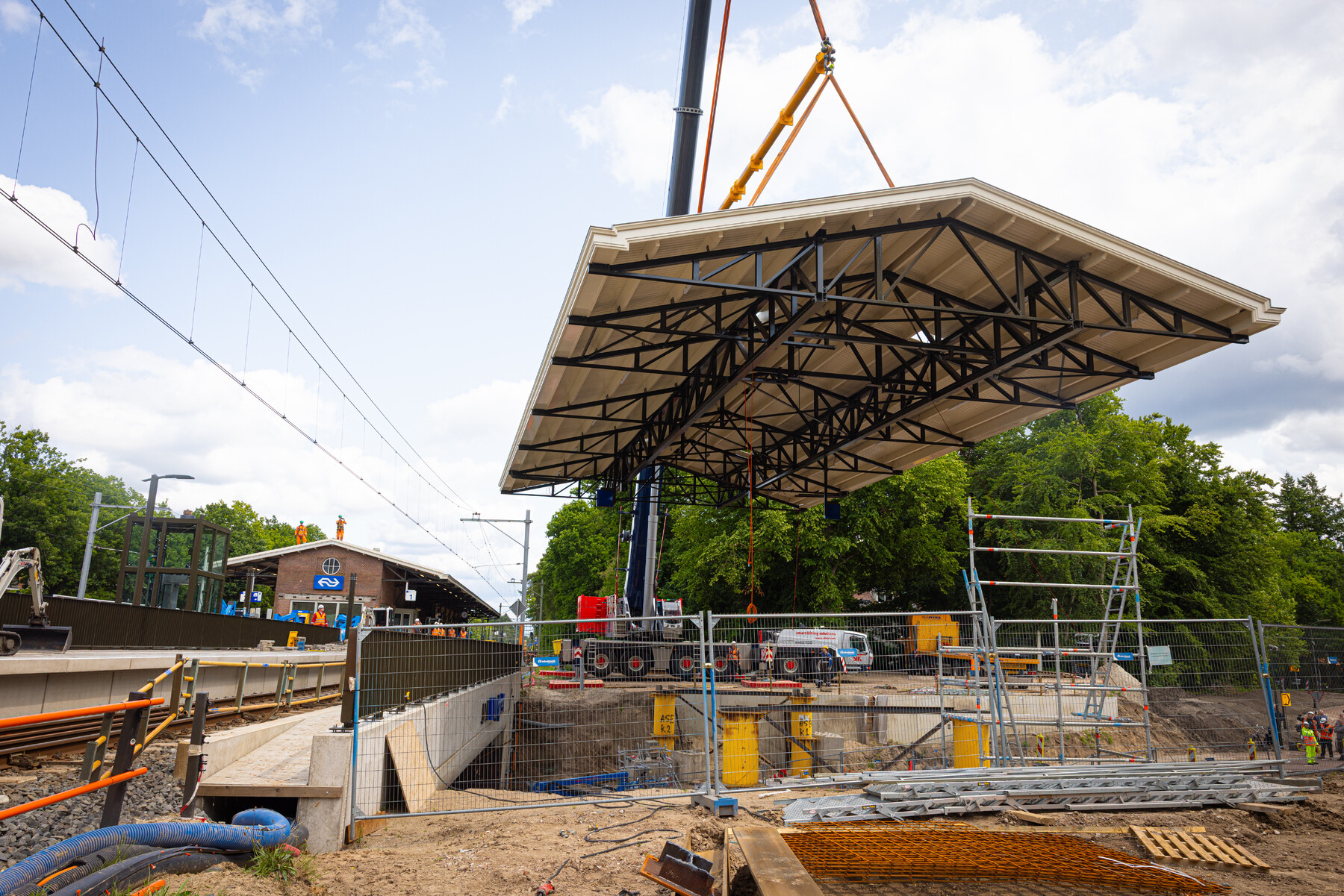 De perronkap is voorgebouwd, vlak naast het station, en werd vanaf daar op z'n plek gehesen