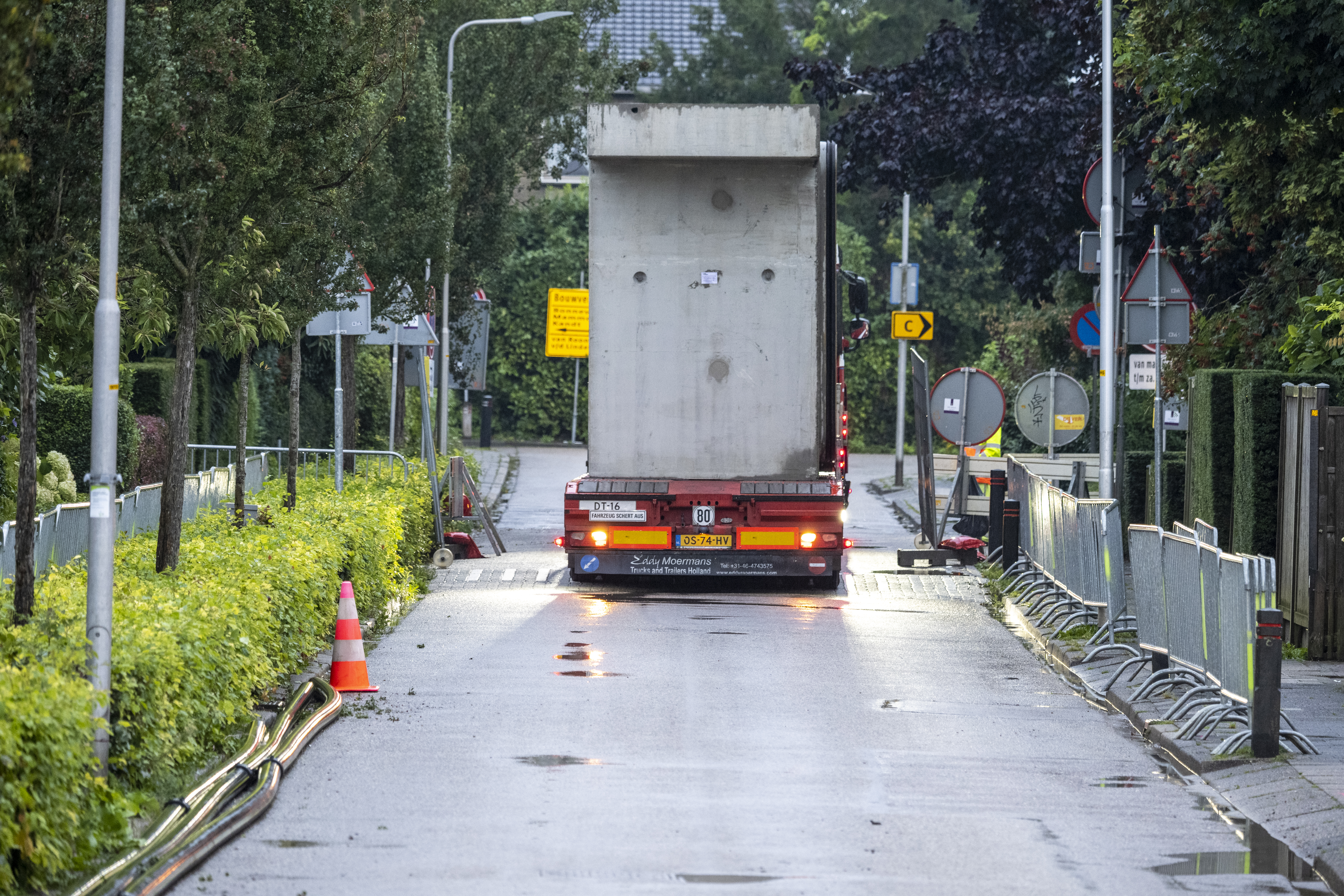 Vrachtwagens rijden de betonelementen één voor één Tricht binnen naar de hijskraan