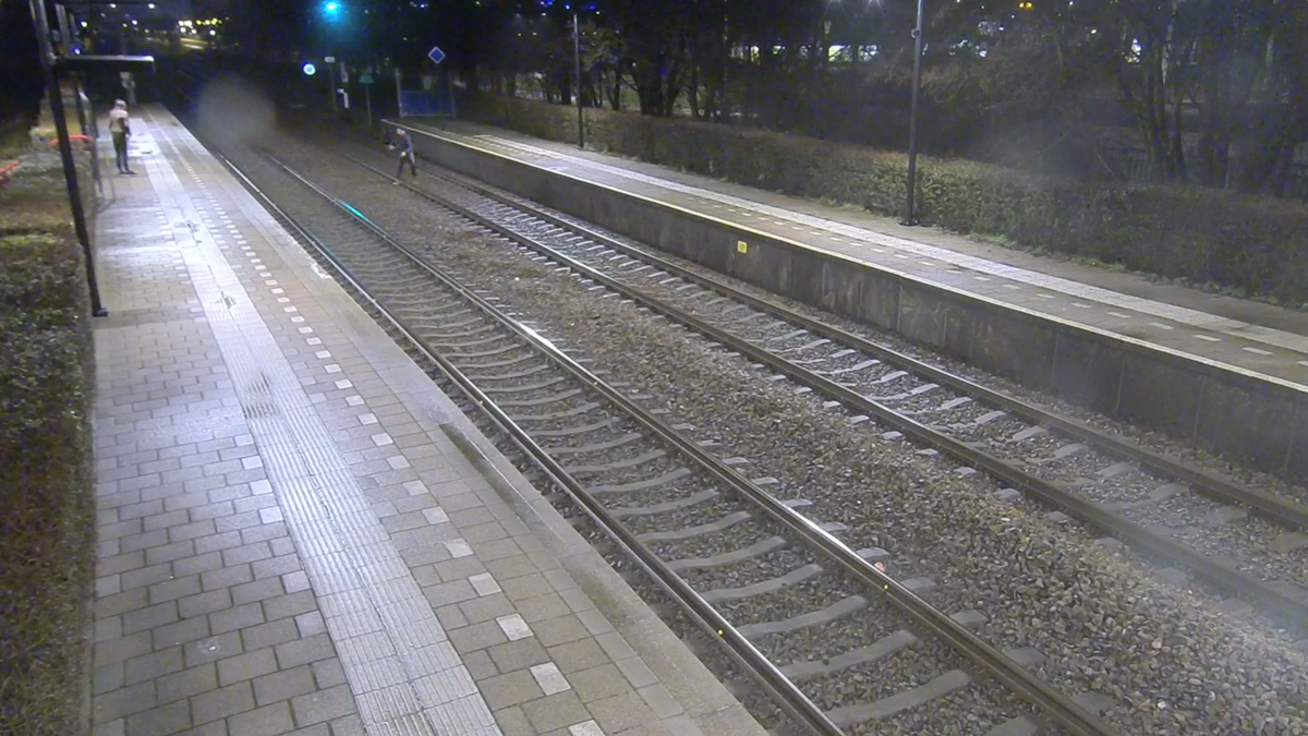 Camerabeeld van spoorlopers op station Alkmaar Noord